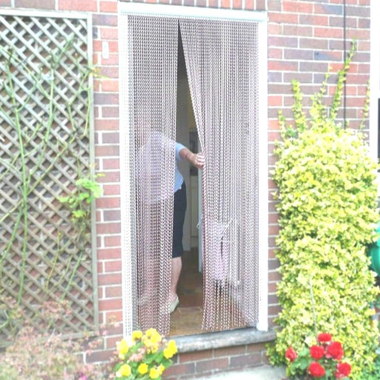 A silver metal chain curtain hanging in an open front doorway
